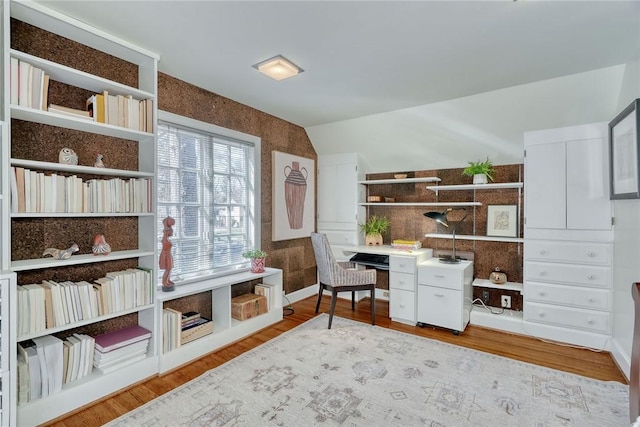 office with wood finished floors and vaulted ceiling