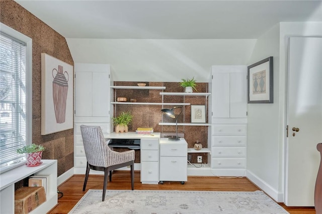 home office featuring baseboards and wood finished floors