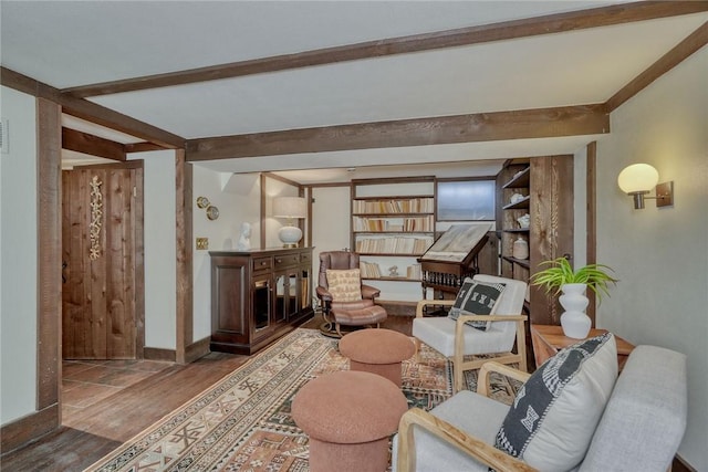 sitting room featuring beam ceiling, wood finished floors, baseboards, and visible vents