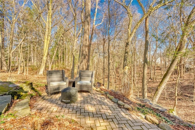 view of patio featuring a forest view