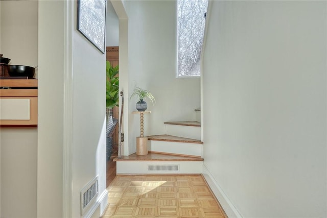 stairway with visible vents and baseboards