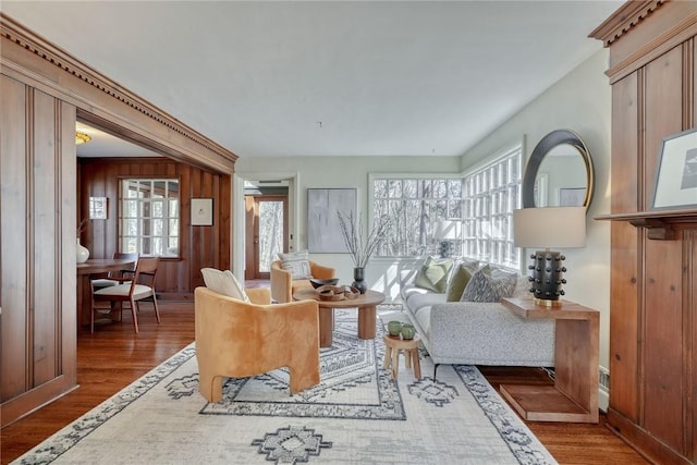 living room featuring wooden walls and wood finished floors