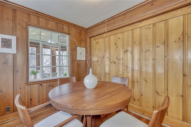 dining room featuring wood walls