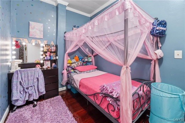 bedroom featuring baseboards, wood finished floors, and ornamental molding