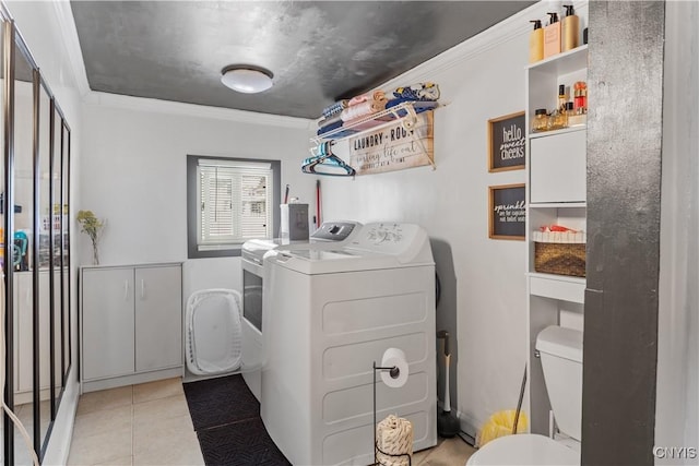 laundry room featuring light tile patterned floors, laundry area, washing machine and dryer, and ornamental molding