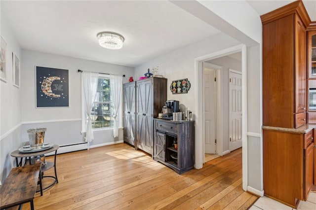 entrance foyer with baseboards and light wood-style floors