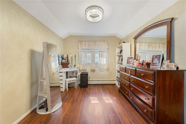 bedroom featuring a baseboard radiator, baseboards, dark wood-style floors, and vaulted ceiling