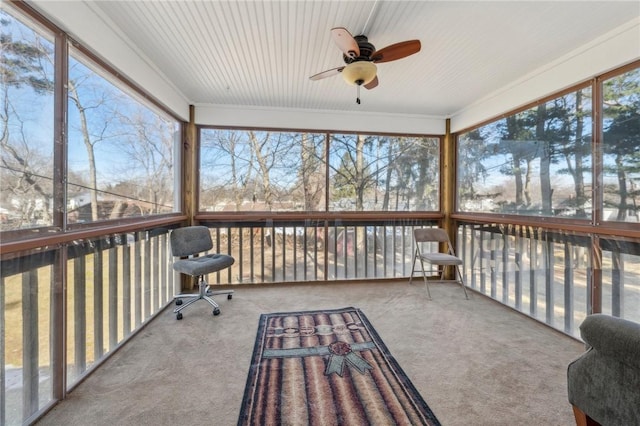 sunroom / solarium featuring a ceiling fan