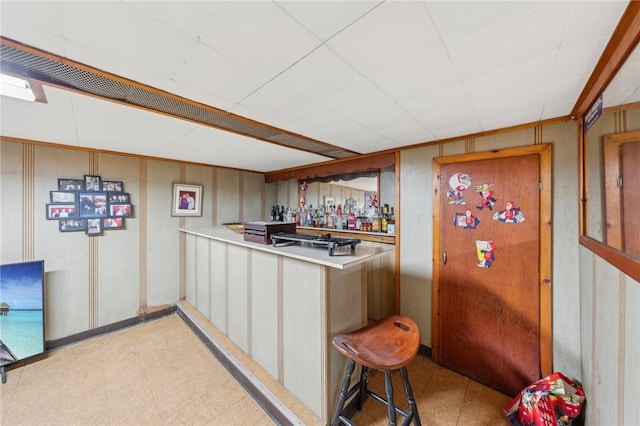 bar with light floors and a dry bar