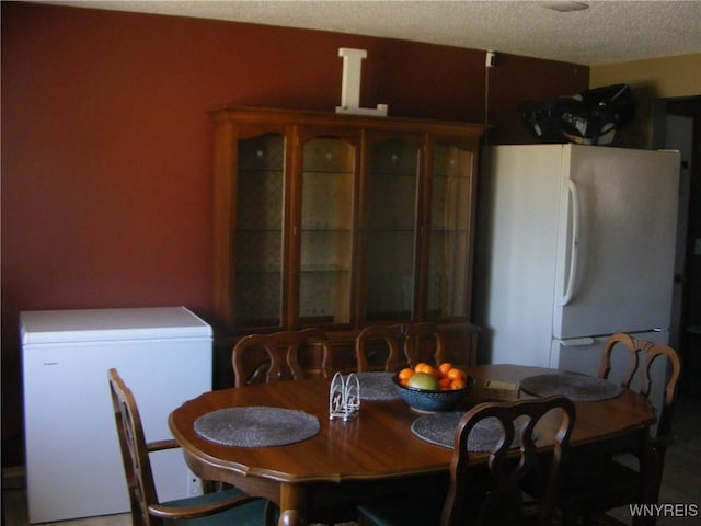 dining area with a textured ceiling