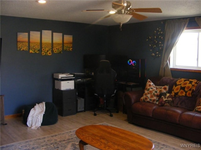 living room featuring ceiling fan and wood finished floors