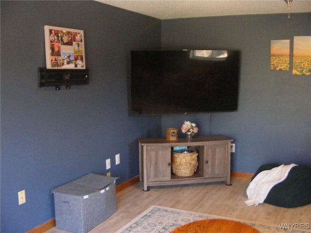 bedroom featuring wood finished floors and baseboards