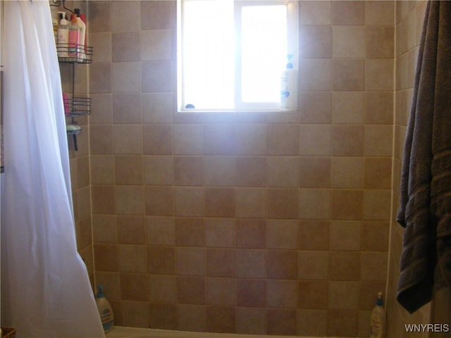 bathroom with a tile shower