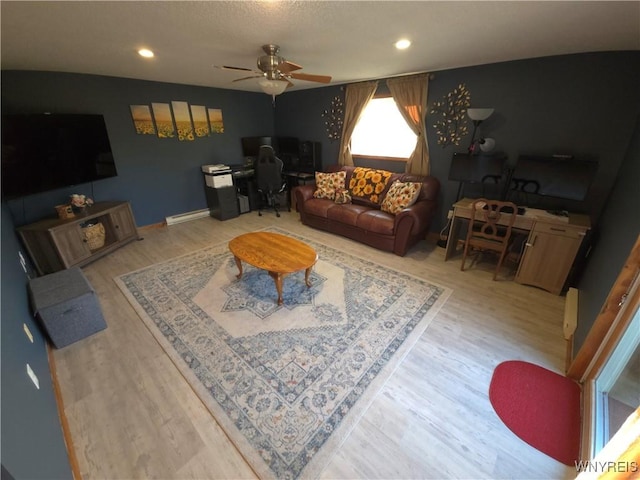 living area featuring recessed lighting, wood finished floors, and a ceiling fan