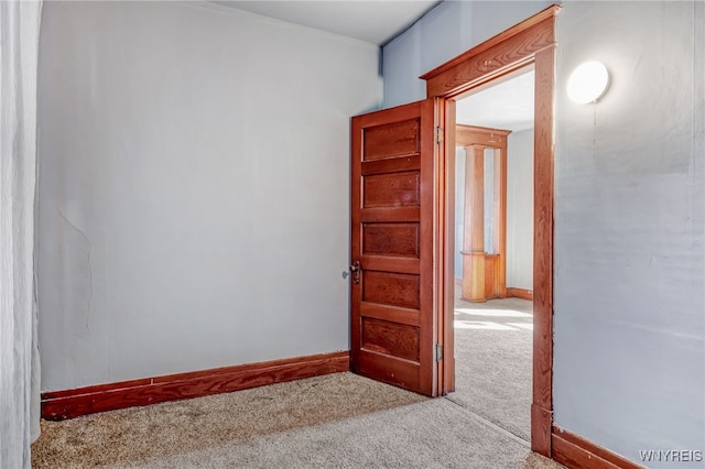 carpeted spare room with baseboards