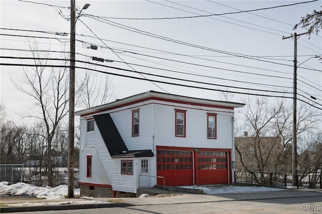 view of front of property featuring crawl space, a garage, and fence