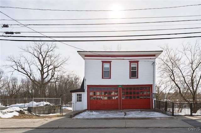 exterior space with a garage and fence