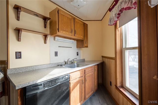 kitchen with plenty of natural light, brown cabinets, black dishwasher, and a sink