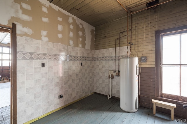 bathroom with water heater, wooden ceiling, tile walls, and hardwood / wood-style flooring