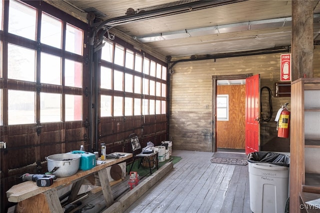 garage featuring wood walls