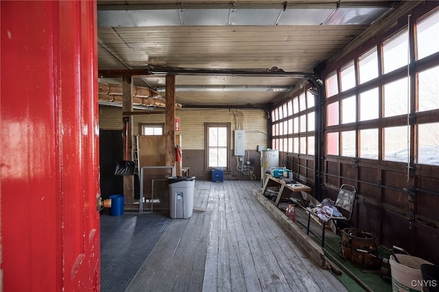 interior space featuring hardwood / wood-style floors, electric panel, and a garage