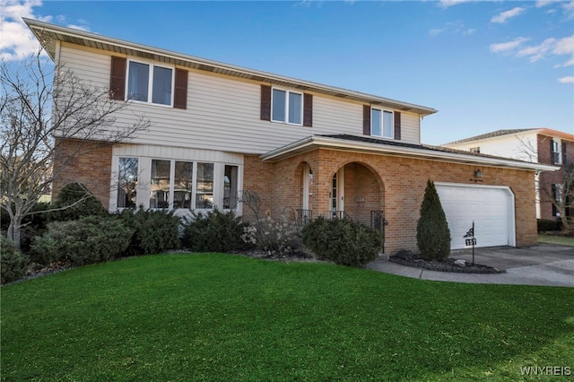 traditional-style house with brick siding, an attached garage, concrete driveway, and a front yard