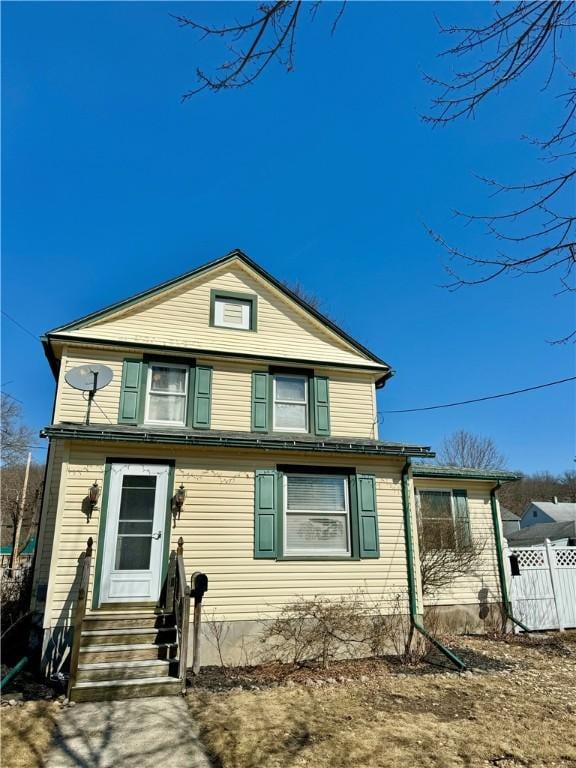 view of front of home with fence and entry steps