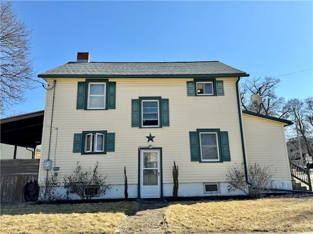 view of front of house featuring a chimney, a front yard, and fence