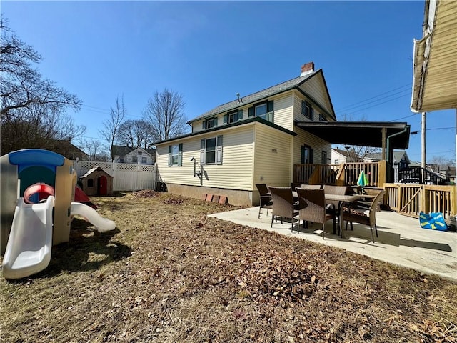 464 Pine St, Erwin, NY 14870 - back of house featuring a patio area, a chimney, a playground, and fence
