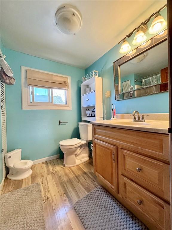 464 Pine St, Erwin, NY 14870 - bathroom featuring baseboards, toilet, a shower with shower curtain, wood finished floors, and vanity