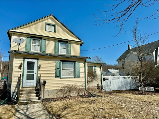 view of front of house featuring entry steps and fence