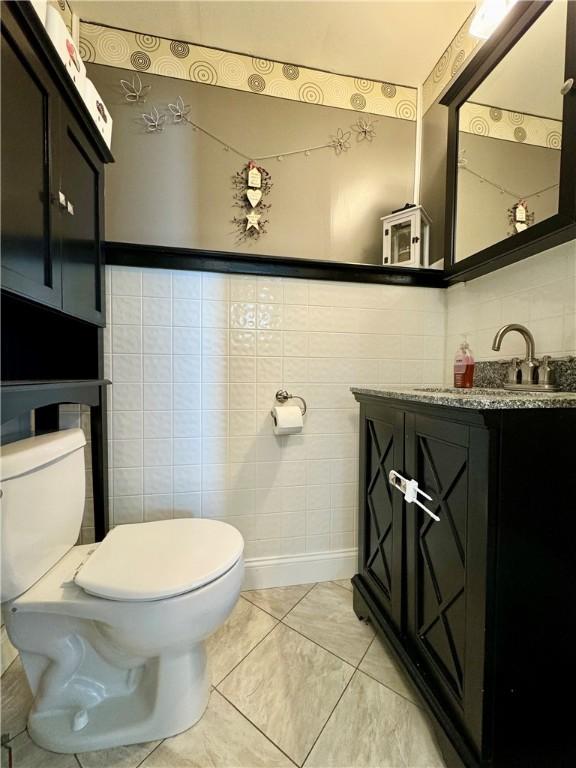 464 Pine St, Erwin, NY 14870 - half bathroom featuring toilet, tile walls, and vanity