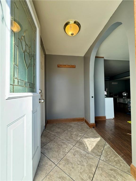 464 Pine St, Erwin, NY 14870 - doorway with arched walkways, tile patterned flooring, and baseboards