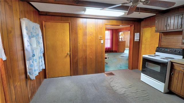 kitchen with white range with electric stovetop, beam ceiling, wooden walls, and carpet floors