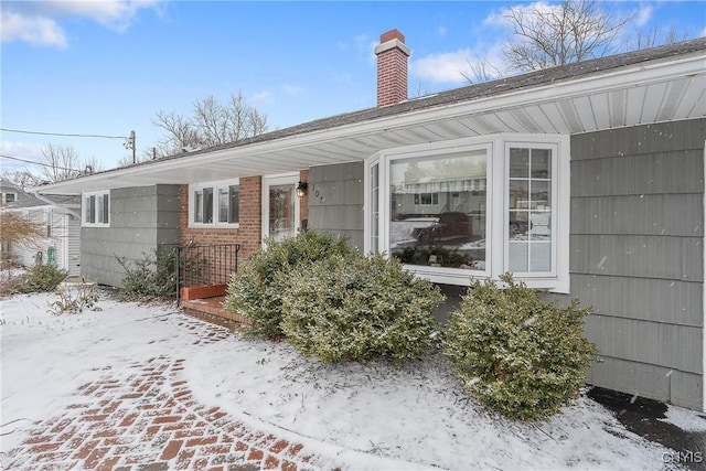 doorway to property featuring a chimney