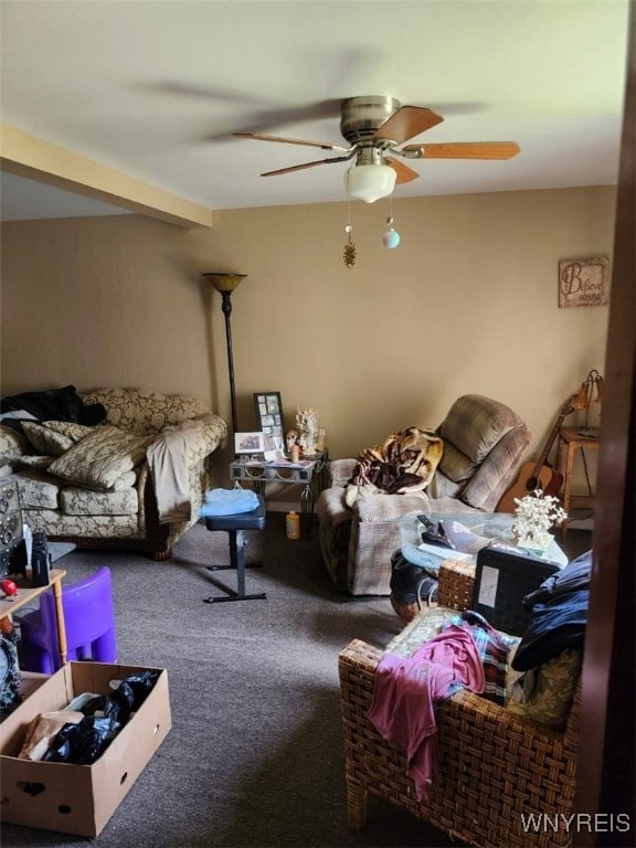 carpeted living room featuring beam ceiling