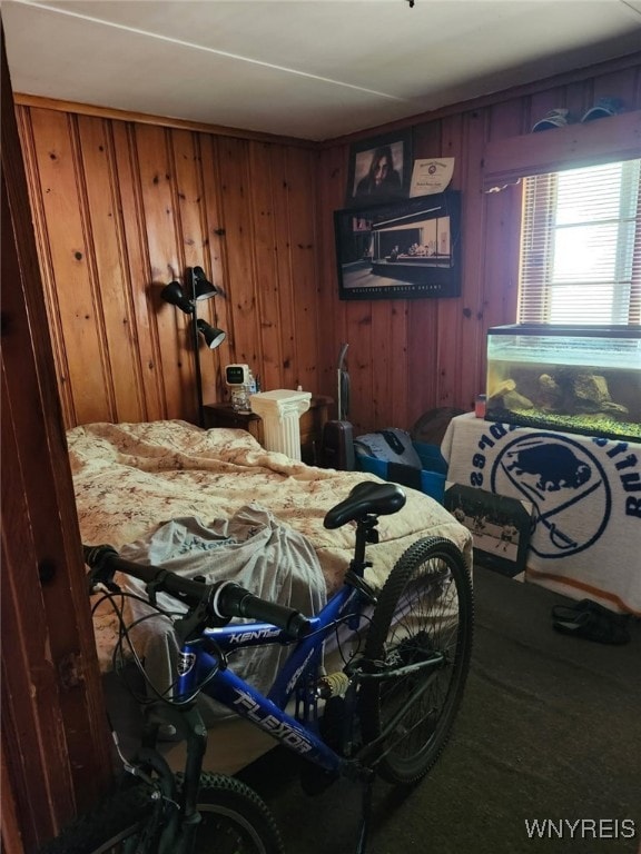 bedroom with wood walls