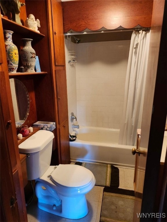 bathroom with tile patterned floors, shower / tub combo, and toilet