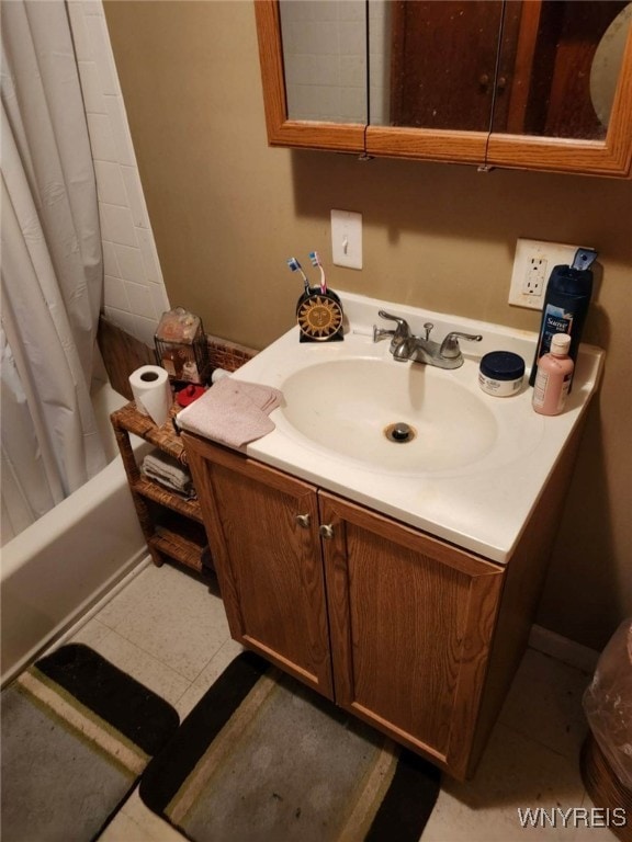 bathroom with shower / bath combo, vanity, and tile patterned flooring