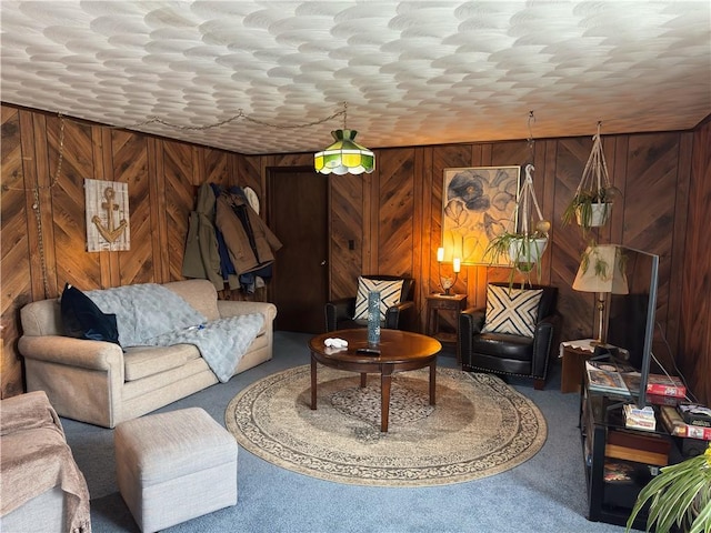 sitting room with wooden walls and carpet flooring