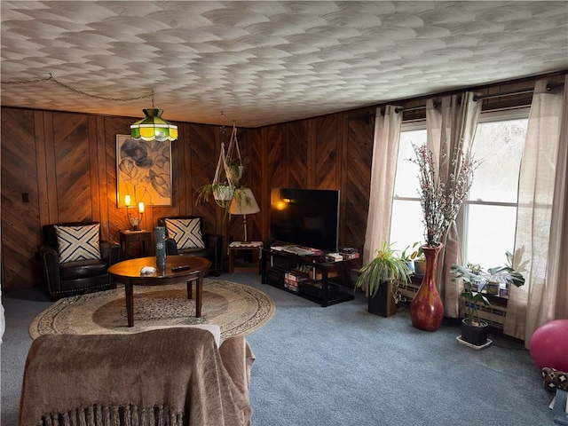 sitting room featuring wooden walls and carpet