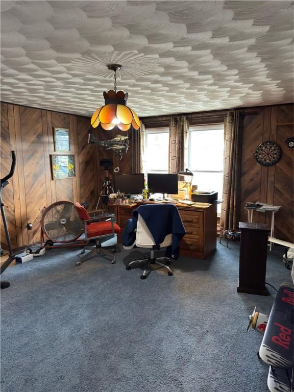 carpeted home office with wooden walls