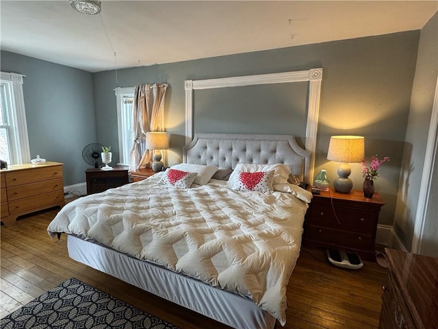 bedroom with hardwood / wood-style floors and baseboards