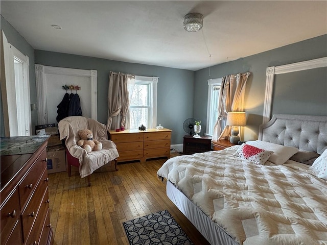 bedroom with dark wood-type flooring