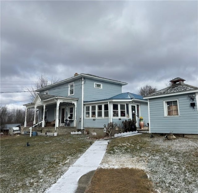 back of property with a porch