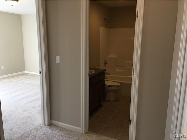 bathroom featuring baseboards, toilet, shower / bathtub combination, tile patterned floors, and vanity