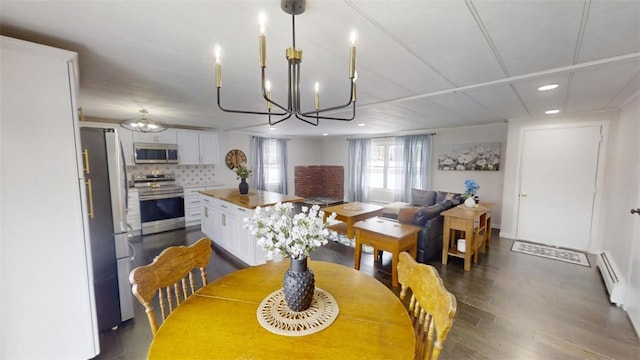 6339 County Road 32, North Norwich, NY 13815 - dining space with dark wood-style flooring, a baseboard radiator, recessed lighting, and a chandelier