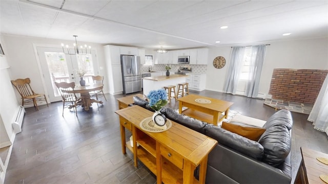 6339 County Road 32, North Norwich, NY 13815 - living room featuring baseboards, a notable chandelier, a baseboard radiator, dark wood-style floors, and recessed lighting