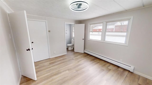 6339 County Road 32, North Norwich, NY 13815 - unfurnished bedroom featuring a baseboard heating unit, light wood-type flooring, baseboards, crown molding, and ensuite bath