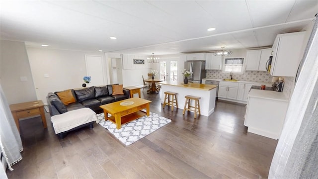 6339 County Road 32, North Norwich, NY 13815 - living room featuring recessed lighting, an inviting chandelier, and wood finished floors